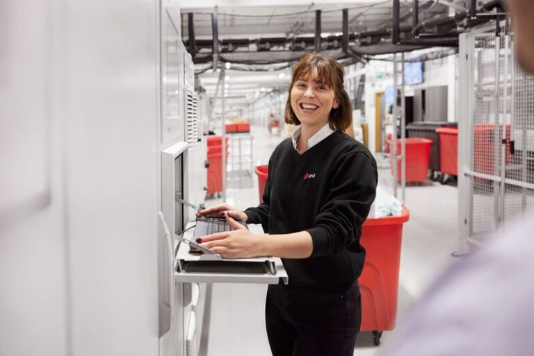 DPD Ireland employee at computer in the warehouse