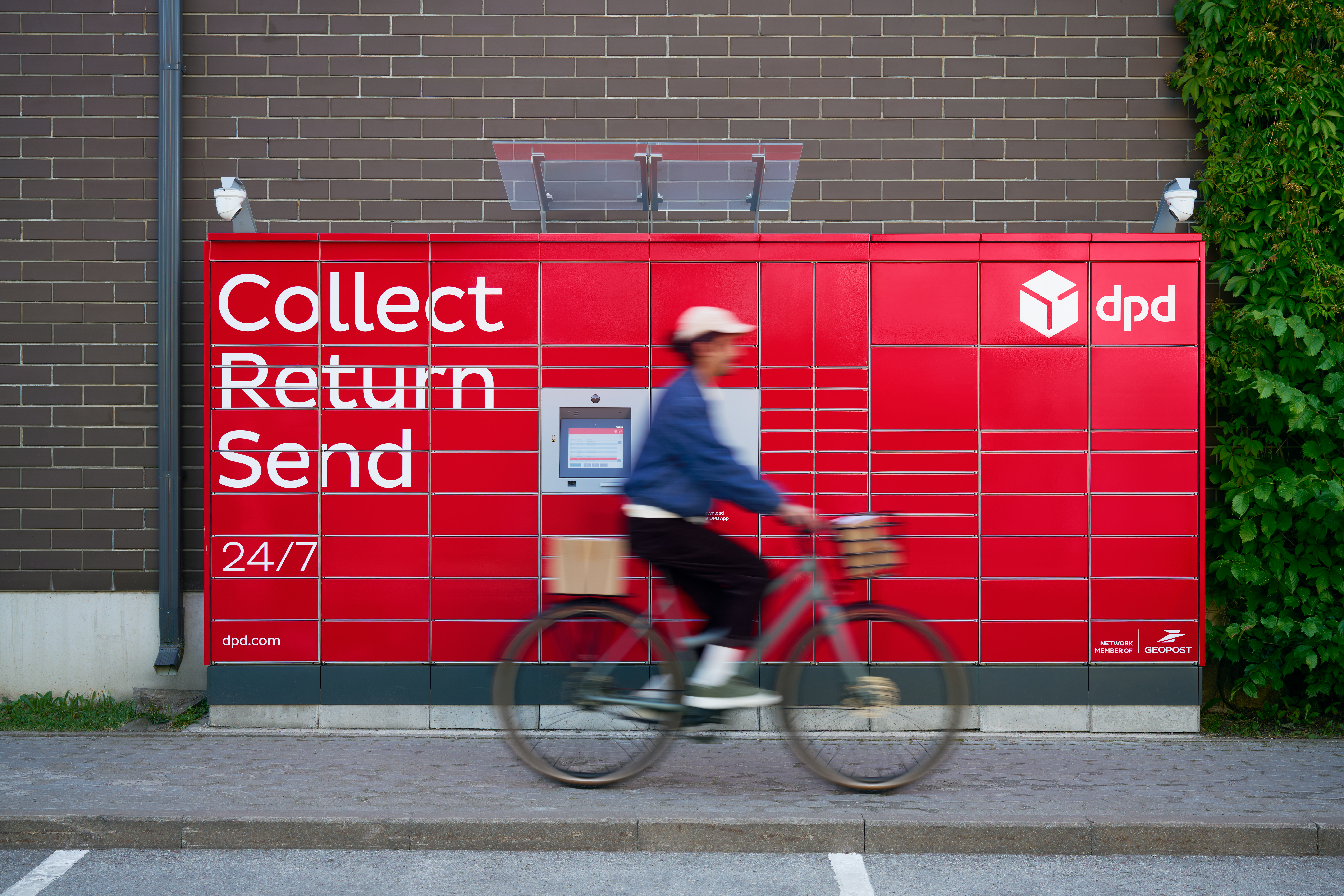 lady cycling past delivery locker